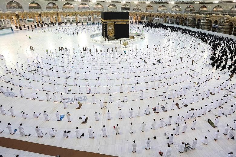 Muslim worshippers praying around the Kaaba in the Grand Mosque complex in Mecca, Islam's holiest shrine, in Saudi Arabia. Millions of Muslims from across the world travel to Saudi Arabia on umrah pilgrimages throughout the year. These involve making