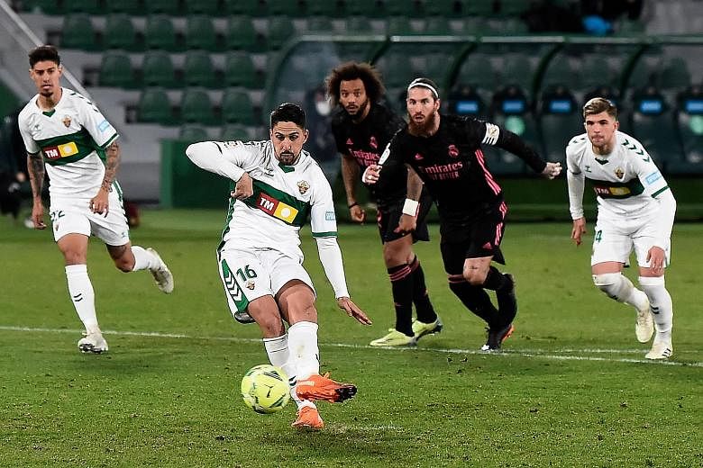 Elche's Fidel Chaves scoring a penalty during the 1-1 draw with Real Madrid. Real remain second, two points behind Atletico Madrid.
