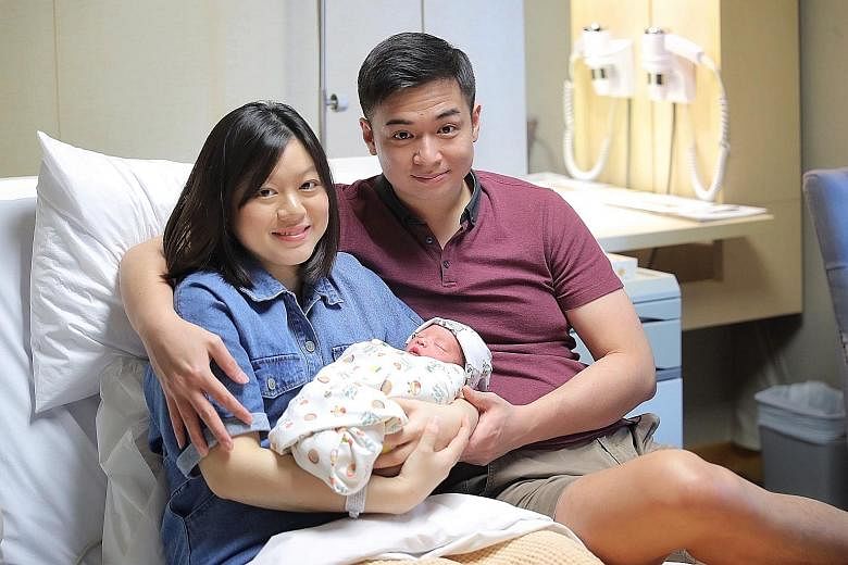 First-time parents Audrey Tjioe and Zemin Tan with their daughter Avery, who was born at the stroke of midnight at Raffles Hospital.