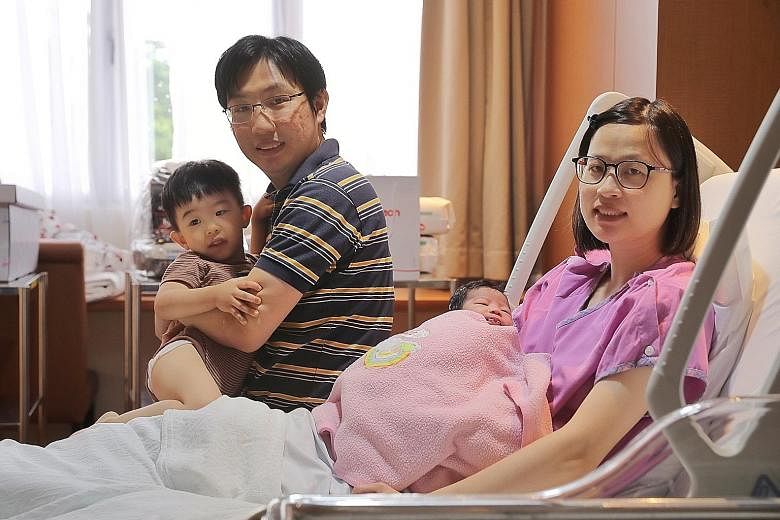 Ms Yu Hui-Lan and Mr David Chan with their two-year-old son Nolen and the newest addition to their family, a baby girl, at Mount Alvernia Hospital yesterday.