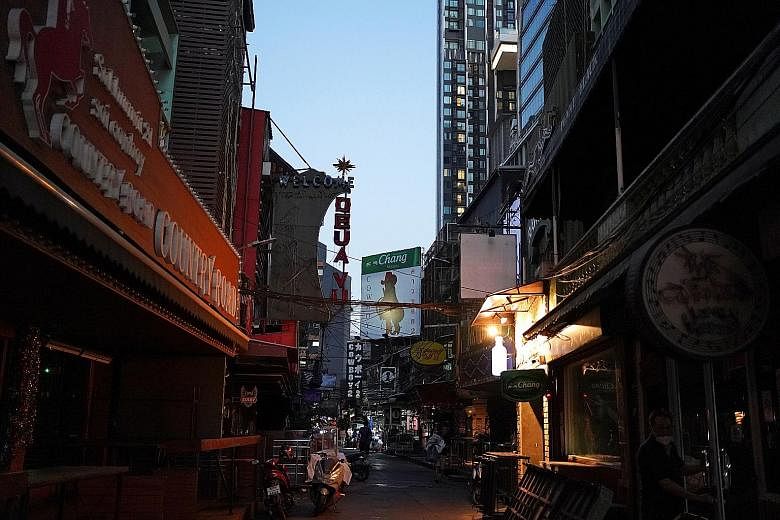 Shuttered go-go bars and massage parlours in Bangkok yesterday after the city authorities ordered a partial lockdown of various public facilities. Public schools will be closed for two weeks, while more than a dozen virus checkpoints have been set up