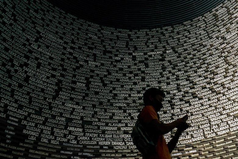 People visiting a hall with a list of names at the Tsunami Museum in Indonesia's Banda Aceh yesterday, following the 16th anniversary of the disaster last week. The hall is dedicated to victims of the 2004 Boxing Day tsunami that killed around 170,00
