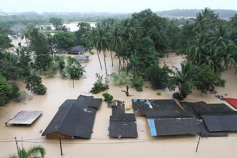 An aerial shot of Kampung Laut Skudai in Johor, where floodwaters during this monsoon season have submerged houses, forcing villagers to seek shelter at a school. The Malaysian Meteorological Department has issued a red alert warning of continuous he