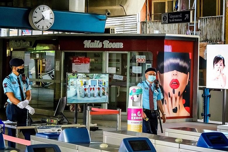 Shuttered go-go bars and massage parlours in Bangkok yesterday after the city authorities ordered a partial lockdown of various public facilities. Public schools will be closed for two weeks, while more than a dozen virus checkpoints have been set up