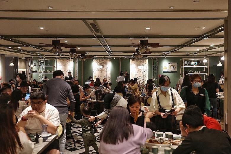 The crowds ventured out of their homes with the easing of curbs as phase three began. On Friday, for example, many diners were seen at Kai Duck (above) in Ngee Ann City. A line of people (right) also formed to get into a JD Sports outlet in ION Orcha