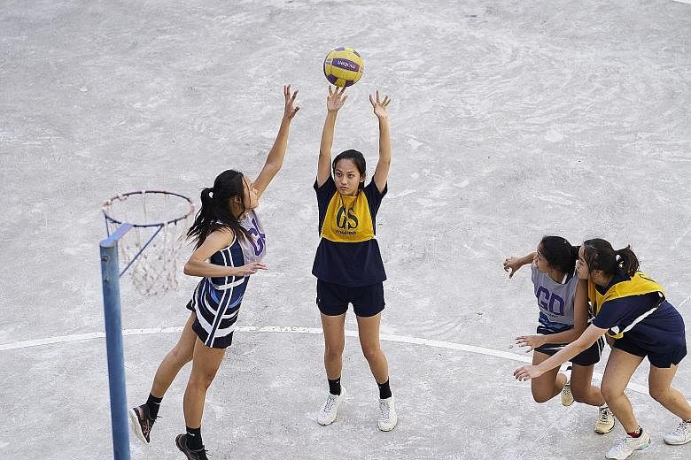 Left: SAJC netball goal shooter Rachel Wong taking a shot during a training session as Demetria Ho defends. They are joined by Amelia Chu (far right) and Tara Nur Alisha Faris. Below: Peicai softballer Nur Aliya Natasya was hoping to compete for the 