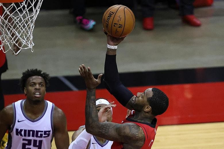 Houston's John Wall putting up a basket during their 102-94 win over Sacramento on Saturday. The point guard helped secure back-to-back victories over Sacramento with game highs of 28 points, six assists and three steals.
