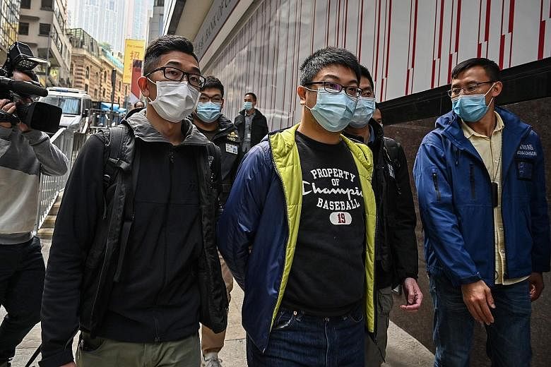 American lawyer John Clancey, who served as treasurer for a group that helped to organise the unofficial primary election in Hong Kong last year, was among the 53 activists arrested yesterday. PHOTO: NYTIMES Pro-democracy activist Lester Shum (centre