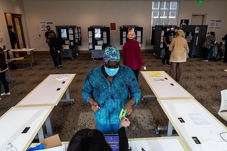 A voter at a polling station during the United States Senate run-off elections in Atlanta, Georgia, on Tuesday. Local organisers in the state, many of them black women, have relentlessly worked for years to increase voter registration among black, As