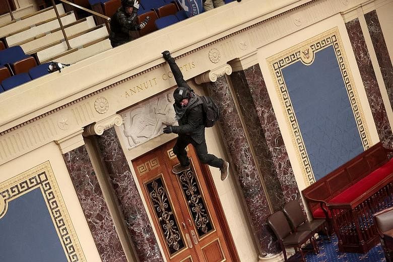 Above: Members of Congress being evacuated from the House chamber as a mob attempted to enter during a joint session of Congress on Wednesday. Left: A protester hanging from the balcony in the Senate chamber. Above: A Trump supporter with his foot up