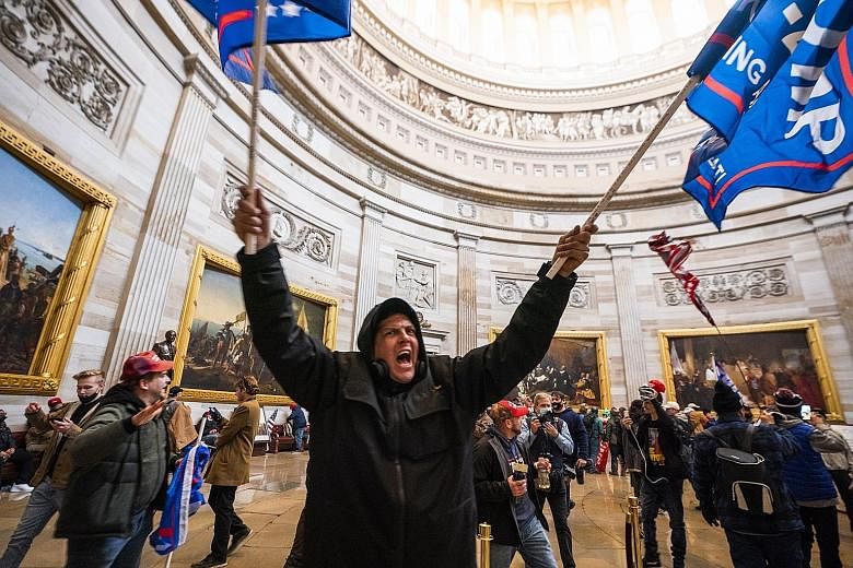 Trump supporters in the Capitol Rotunda after storming the United States Capitol building on Wednesday, forcing lawmakers to flee to safety and suspending proceedings to discuss the states' Electoral College votes for last November's presidential ele