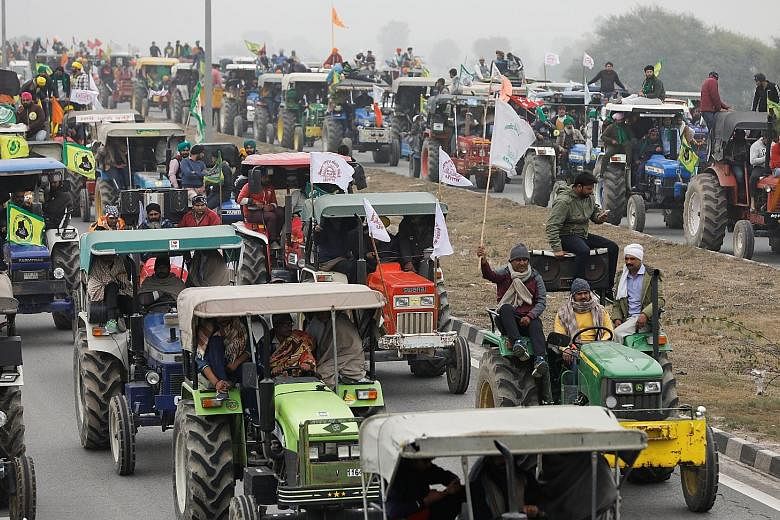 In one of the biggest shows of strength, farmers participating in a tractor rally to protest against three new farm laws, at Singhu border near New Delhi, yesterday. PHOTO: REUTERS