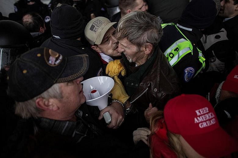 Members of law enforcement clashing with pro-Trump protesters as they stormed the US Capitol on Wednesday. Given the current rates of spread of the coronavirus and the crowd size at the event, experts say the virus would have had the ideal opportunit