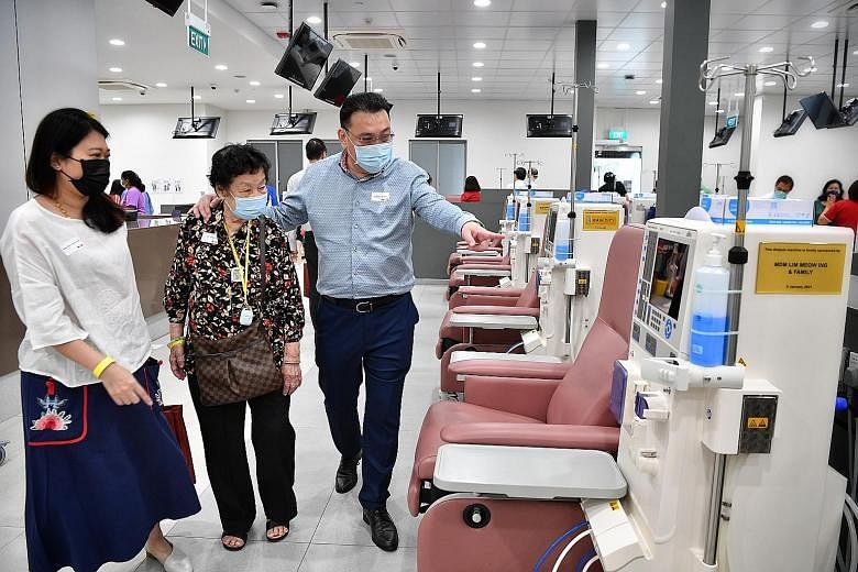 Mr Kenny Teo, managing director of Gain City, with his mother Lim Meow Ing and wife Chiam Bee Ling yesterday at the National Kidney Foundation's new dialysis centre in Yuhua, to which he donated two dialysis machines - one under Gain City's name, and