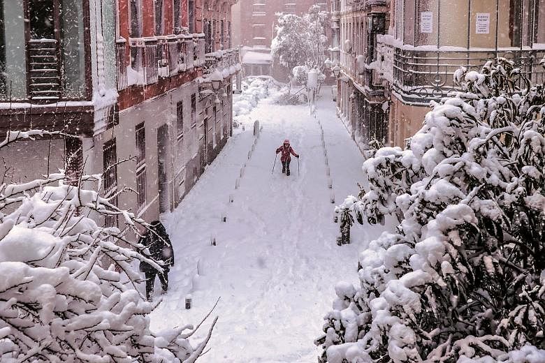 A snow-covered street in Madrid after Storm Filomena brought the heaviest snowfall in the Spanish capital since 1971. Four other regions in Spain were also on red alert yesterday, with more heavy snowfalls forecast.