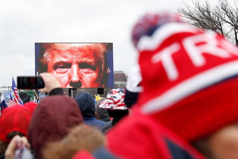 US President Donald Trump speaking to supporters on a screen during a rally in Washington last Wednesday. House Speaker Nancy Pelosi said in a statement on Friday that if Mr Trump does not ''immediately resign'', the House will move forward with a motion 