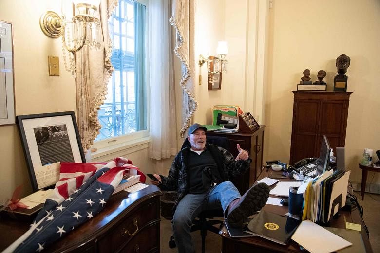 Richard Barnett, who invaded Speaker Nancy Pelosi's office last Wednesday during the storming of the Capitol by Trump supporters, was charged with theft of stationery by the US Justice Department. PHOTO: AGENCE FRANCE-PRESSE