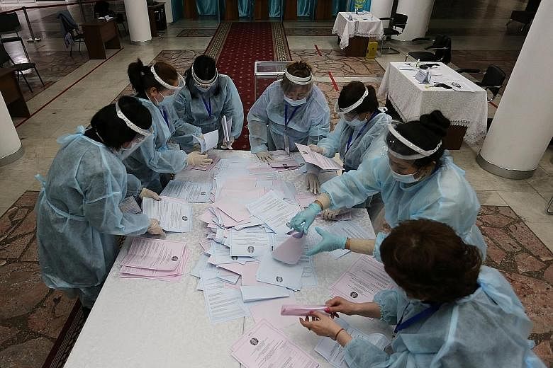 Members of a local electoral commission counting parliamentary election ballots in Almaty, Kazakhstan, on Sunday after polls closed. An exit poll gave the ruling Nur Otan party nearly 72 per cent of the vote.