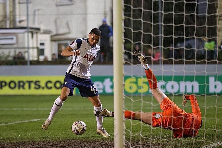 Tottenham Hotspur striker Carlos Vinicius beating Marine goalkeeper Bayleigh Passant to score the opening goal of their English FA Cup third round match at Rossett Park. The Brazilian player added two more for a first-half hat-trick as Spurs clinched
