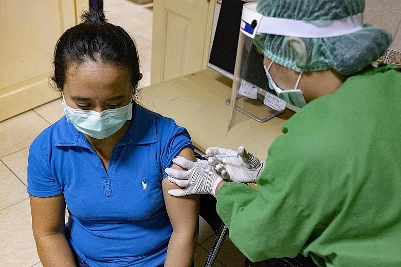 A medical worker administering a jab as part of a Covid-19 vaccination drill yesterday in Bali, Indonesia.