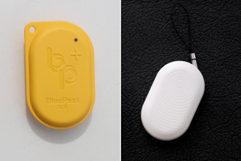 The BluePass token (left) and the TraceTogether token (right) both track close contacts by reading Bluetooth signal strengths. ST PHOTOS: GAVIN FOO