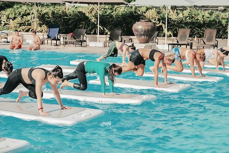 Try burpees, lunges or squats on a floating exercise mat in a pool at Skyline Aqua's FloatFit HIIT class. Students pole dancing at Slap Dance Studio. The activity incorporates dance and acrobatics. Jumping fitness involves aerobic exercises on mini t