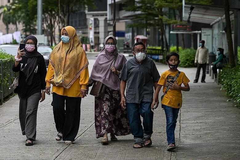 A few pedestrians on a street in Kuala Lumpur yesterday. From today, five states - Melaka, Johor, Penang, Selangor and Sabah - and the federal territories of Kuala Lumpur, Labuan and Putrajaya will re-enter the movement control order, where social ga