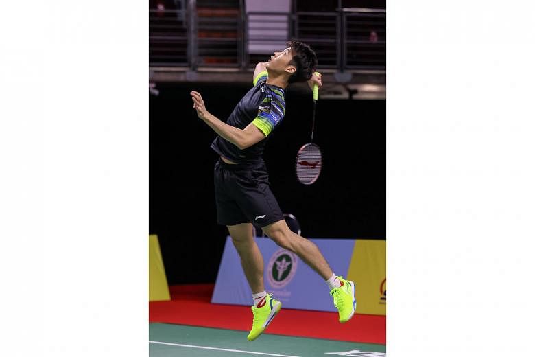 Singapore shuttler Loh Kean Yew returning a shot against Indonesia's world No. 7 Jonatan Christie in the first round of the Yonex Thailand Open. The 23-year-old lost 13-21, 21-10, 21-16 in 65 minutes. PHOTO COURTESY OF BADMINTONPHOTO
