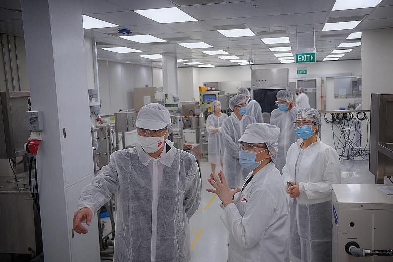 Trade and Industry Minister Chan Chun Sing (far left), with Ms Xue Si-Ying (centre), DuPont Nutrition & Biosciences' innovation leader for Asean, on a tour of DuPont's Dairy and Beverage Lab in Buona Vista yesterday. Mr Chan said Singapore is happy t
