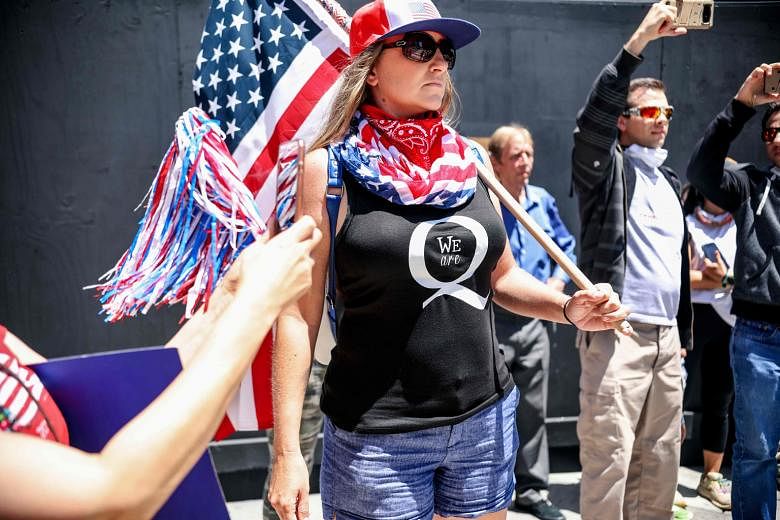 A QAnon supporter at a rally in San Diego, California, in May last year. The FBI considers the loosely connected, cult-like, rambling network of conspiracy theories a domestic terrorism threat.