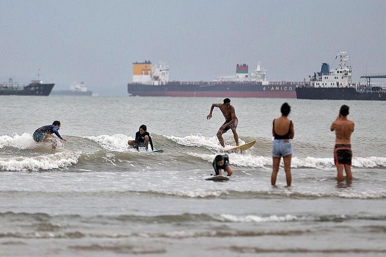 Surfers in Singapore who have been thwarted in chasing the waves overseas by Covid-19 travel restrictions have been flocking to one of the known surf spots in the country. Around 20 surfers were seen there yesterday afternoon - a beach near the Natio