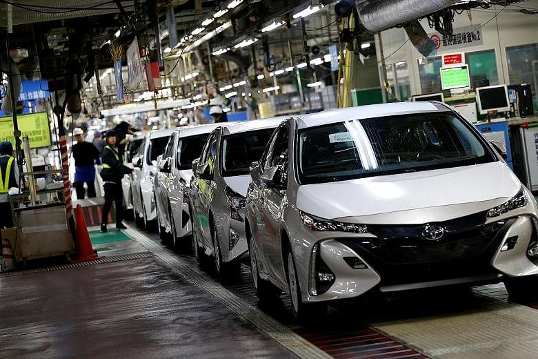 A 2017 file photo of Toyota's Prius PHV and Prius hybrid cars at the company's Tsutsumi plant in Japan. Toyota once built a reputation for clean tech on the back of these cars, but its 2019 decision to support the Trump administration's rollback of t