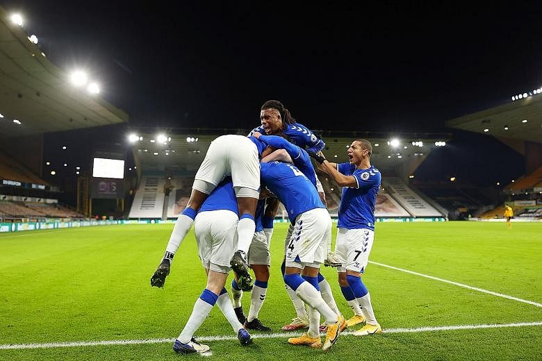 Everton players celebrating Michael Keane's winner in their 2-1 win against Wolverhampton Wanderers on Tuesday at Molineux Stadium.