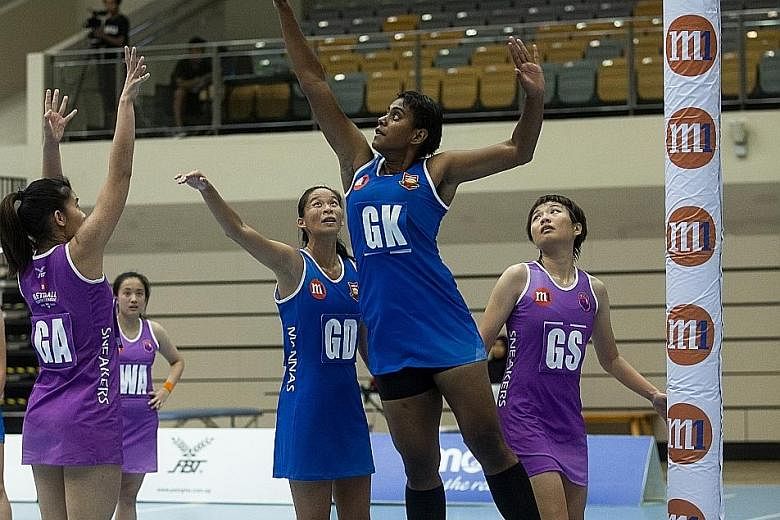 Mission Mannas goalkeeper Ema Mualuvu trying to block a shot by Sneakers Stingrays' goal attack Wong Pei Ying in an NSL game last March. The netballers are trying to stay positive during their modified training sessions while awaiting a decision on t