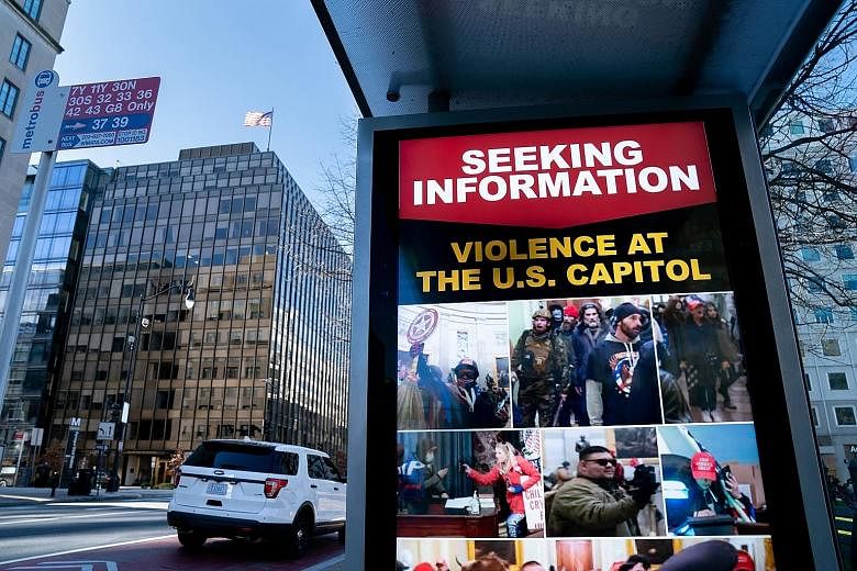 An FBI notice at a bus stop near the White House in Washington, seeking information about the hundreds of pro-Trump protesters who invaded the Capitol on Jan 6.