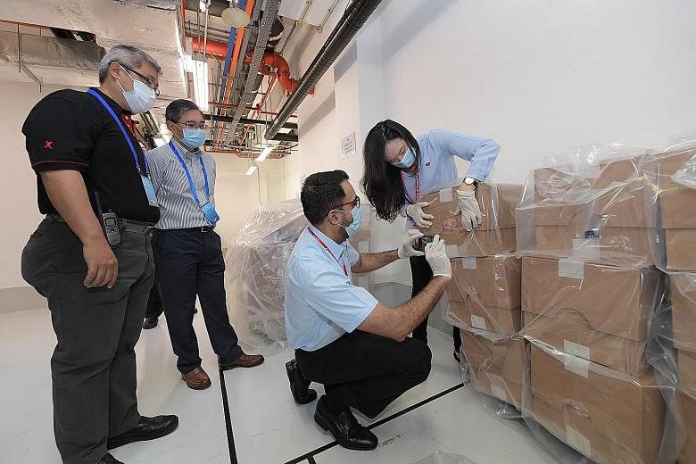 Pasir Ris-Punggol GRC MP Yeo Wan Ling and Nee Soon GRC MP Derrick Goh of the People's Action Party viewing the boxes of ballot papers at Supreme Court. The sealed boxes of ballot papers in the process of being destroyed in front of witnesses at the T