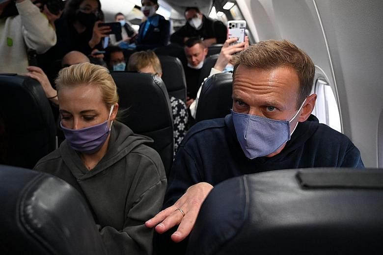 Russian opposition leader Alexei Navalny and his wife Yulia on a plane at Berlin Brandenburg Airport before take-off yesterday. They were returning to Russia after he spent five months in Germany recovering from a poisoning attack. PHOTO: AGENCE FRAN