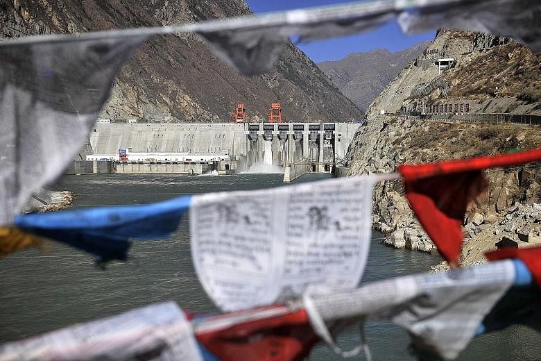 Prayer flags hanging in front of the Zangmu Hydropower Station in China's Tibet Autonomous Region. The Chinese Embassy in New Delhi has denied that China's planned mega dam on the Yarlung Tsangpo River - reportedly less than 50km from the Indian bord