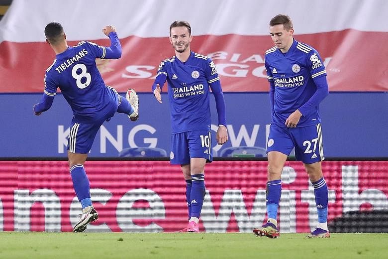 Leicester's James Maddison celebrates with a socially-distanced handshake after scoring the first goal in their 2-0 win over the Saints. PHOTO: EPA-EFE