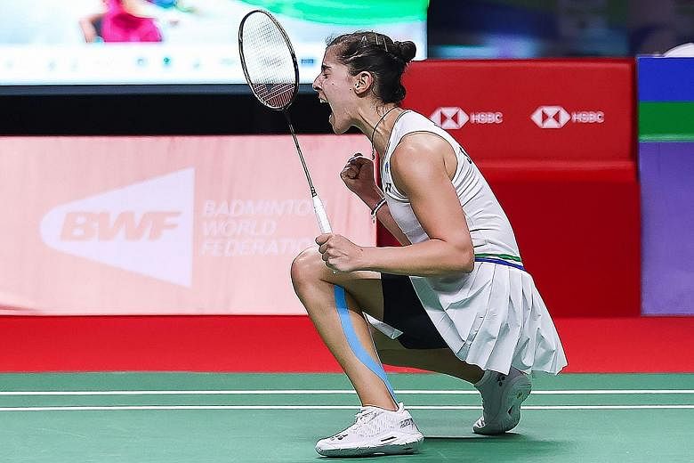 Left: Spain's Carolina Marin screams in delight after beating Chinese Taipei's Tai Tzu-ying 21-9, 21-16 in the women's singles final at the Yonex Thailand Open in Bangkok. Above: Denmark shuttler Viktor Axelsen raises his arms in celebration after de