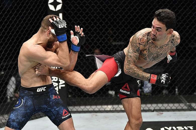 Max Holloway kicking Calvin Kattar in Saturday's UFC Fight Night in Abu Dhabi. He landed a UFC-record 445 significant strikes, while Kattar connected on 133 of them.