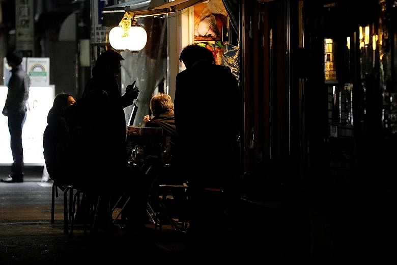People drinking outside a bar in Tokyo last Friday past the 8pm cut-off time. While compliance has been high, more people appear to be ignoring this state of emergency than the one last year. The government has offered subsidies to establishments tha