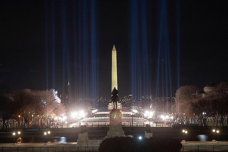 The Washington Monument framed by spotlights on the National Mall on Saturday as preparations were under way ahead of President-elect Joe Biden's inauguration ceremony this Wednesday in Washington. Thousands of National Guard troops have been deploye