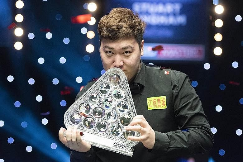 China's Yan Bingtao celebrates by kissing his trophy after beating four-time world champion John Higgins to claim the Masters title in his debut. The 20-year-old is the youngest player in 26 years to win the prestigious snooker tournament.