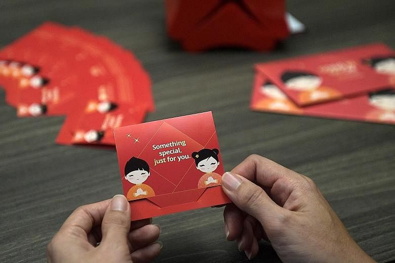 DBS Bank customers have a hybrid option called QR Gift, which involves physical gift cards (above) with QR codes printed on them. ST PHOTO: ALPHONSUS CHERN