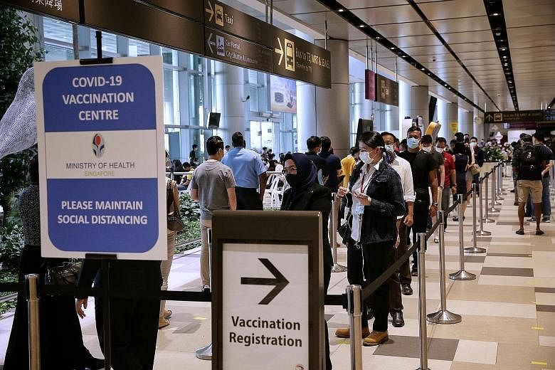 Front-line workers in the aviation industry registering for Covid-19 vaccination at Changi Airport Terminal 4 yesterday. Inoculating front-line workers will also protect Singapore, Transport Minister Ong Ye Kung said, noting that while the situation 