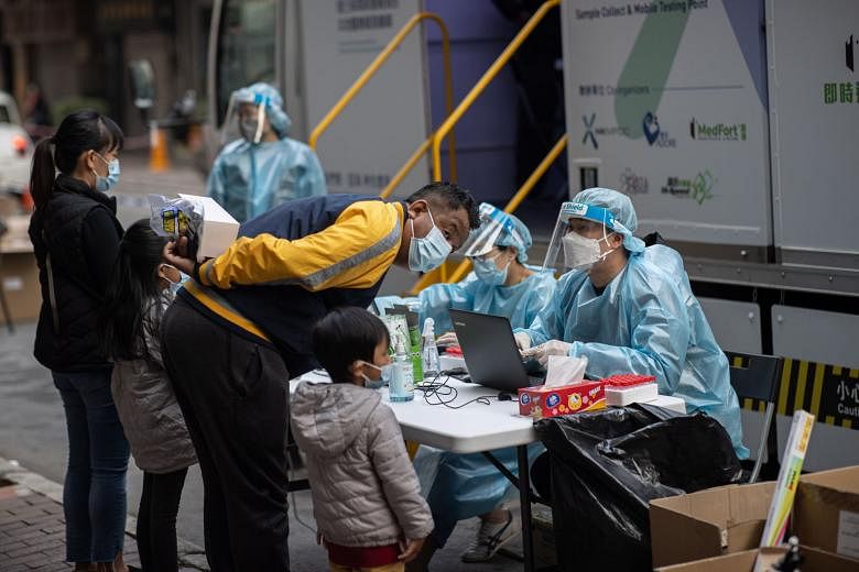 People registering for Covid-19 tests at a mobile testing station in Hong Kong on Sunday. In the last two weeks, the city recorded over 600 new cases, with 160 linked to a cluster in the crowded Yau Ma Tei area.