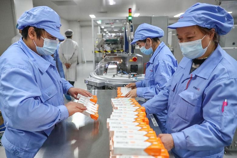 Workers arranging Covid-19 vaccine packages at a Sinovac Biotech production line in Beijing this month. The Chinese firm said its vaccine is more effective if the two-dose regime is administered over a longer time frame.