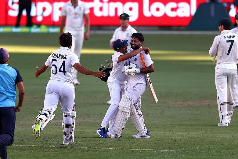 India batsman Rishabh Pant (right) celebrating with his teammates after their fourth Test and away series win over Australia.