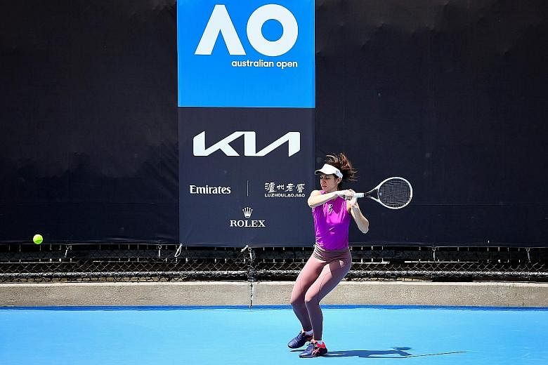 Romania's Ioana Raluca Olaru training ahead of the Australian Open yesterday. While she is able to practise on the court, 72 players are confined to their hotel rooms, where some have resorted to hitting balls against the wall.